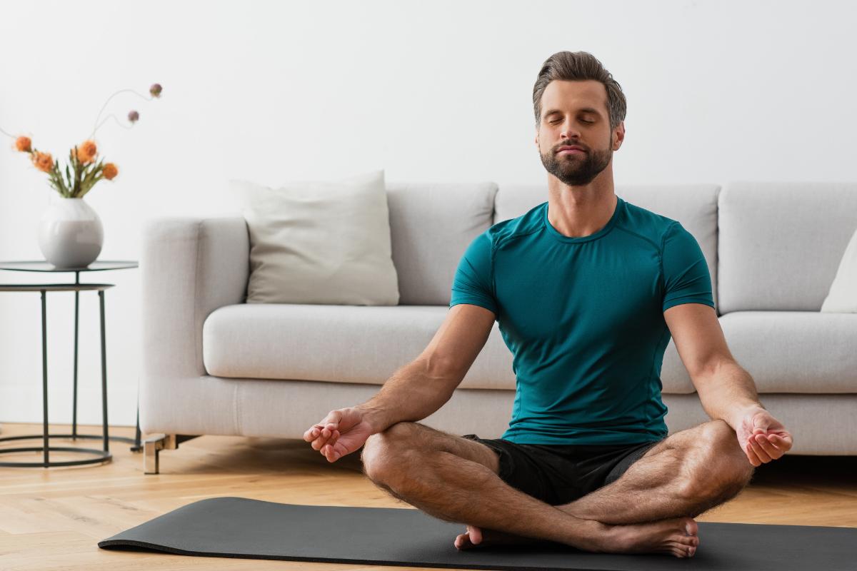 man on yoga mat considering the benefits of holistic treatment