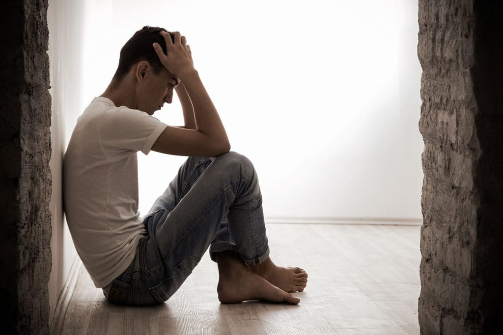 man with head in hands considering the long term effects of fentanyl