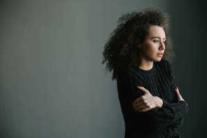 woman with curly hair considers a ptsd treatment program in north carolina 