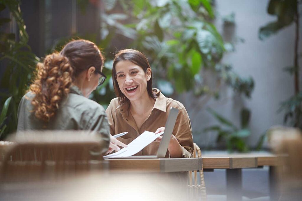 person laughing outdoors while discussing life skills training for substance abuse prevention