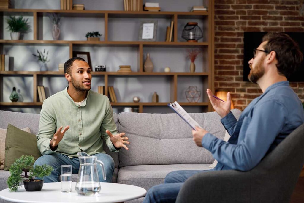 two men talk about what acceptance and commitment therapy is