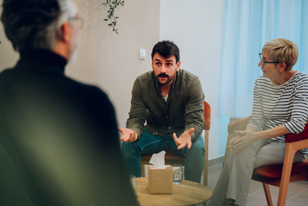 people in group therapy learn about drug addiction treatment benefits