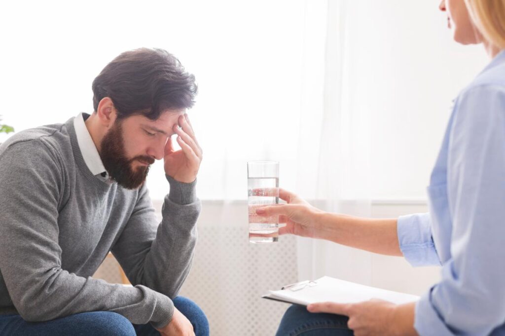 man talks with therapist about what experiential therapy is