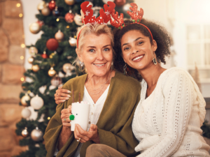 two women smiling in front of tree while considering tips to stay sober