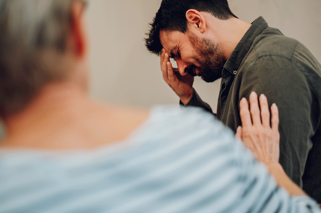 woman comforts man who is wondering if his loved one is addicted to crack